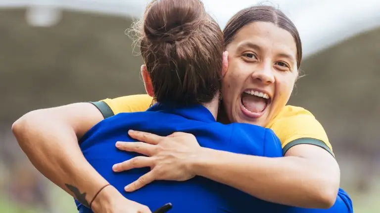 Sam Kerr celebrates with a teammate after returning to Gotham FC on deal through 2030.