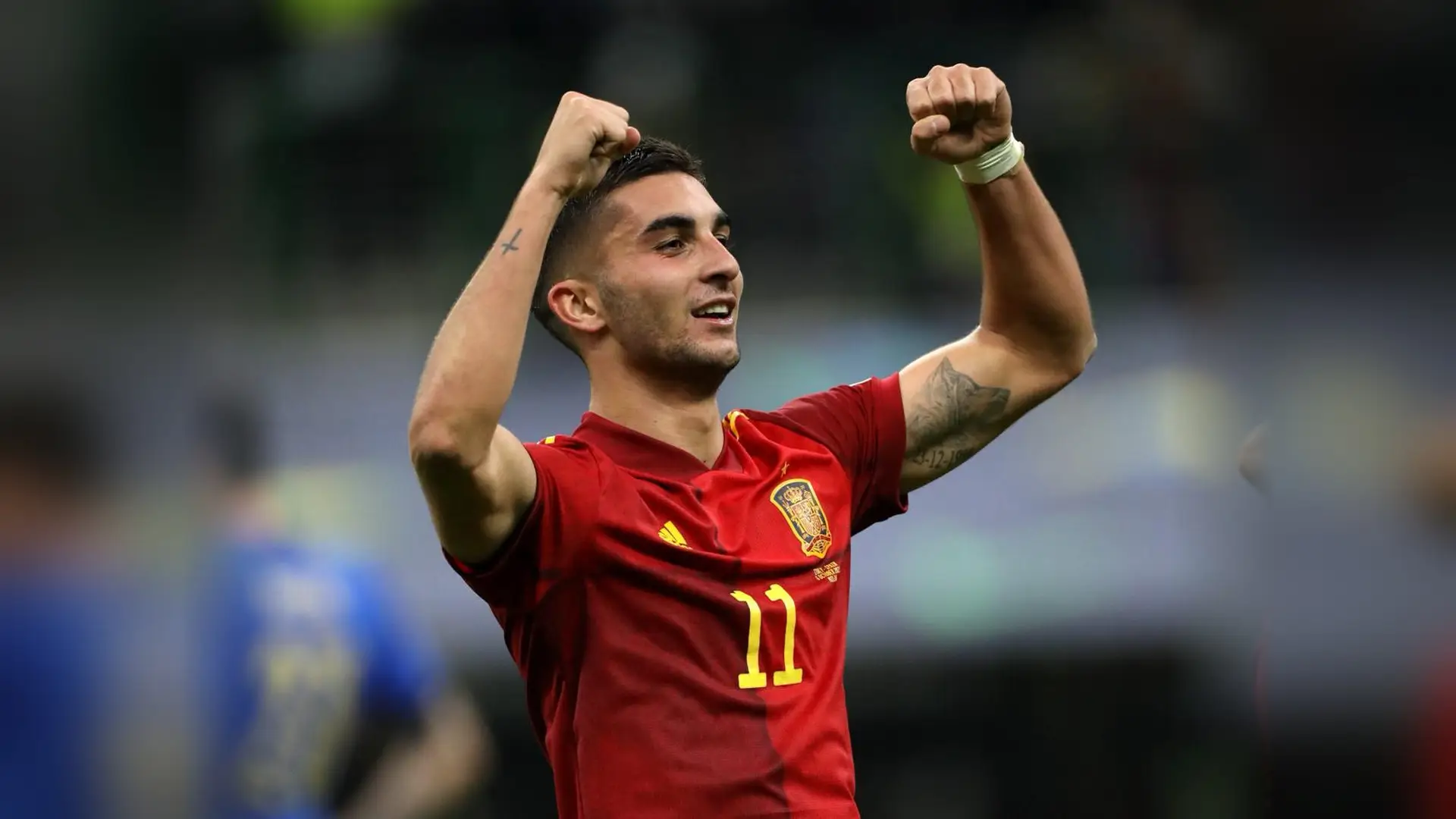 Ferran Torres celebrates for Spain with both arms raised