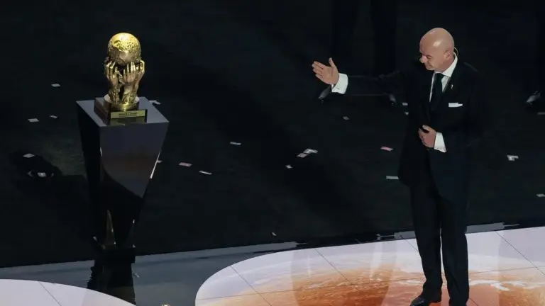 Gianni Infantino gestures toward the World Cup trophy during a FIFA presentation