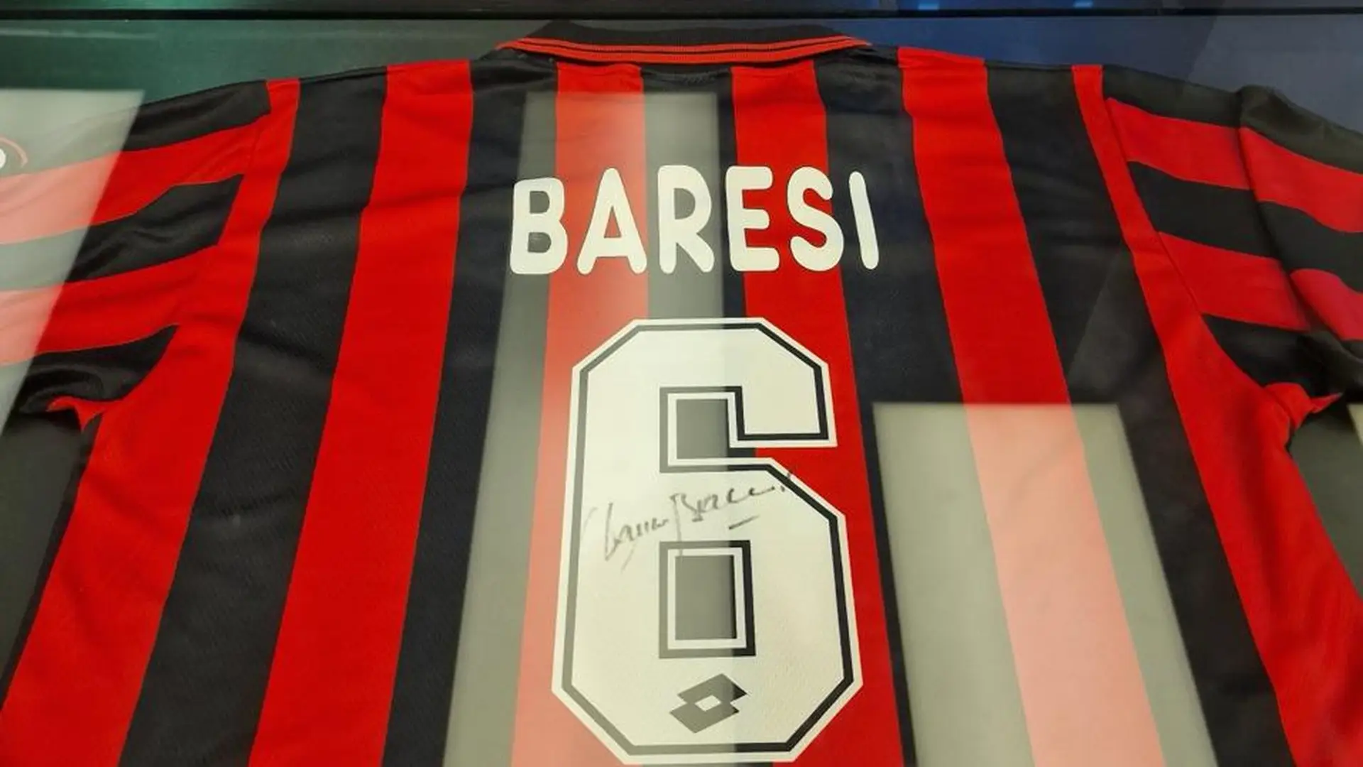 Franco Baresi’s signed No. 6 AC Milan shirt displayed behind glass.
