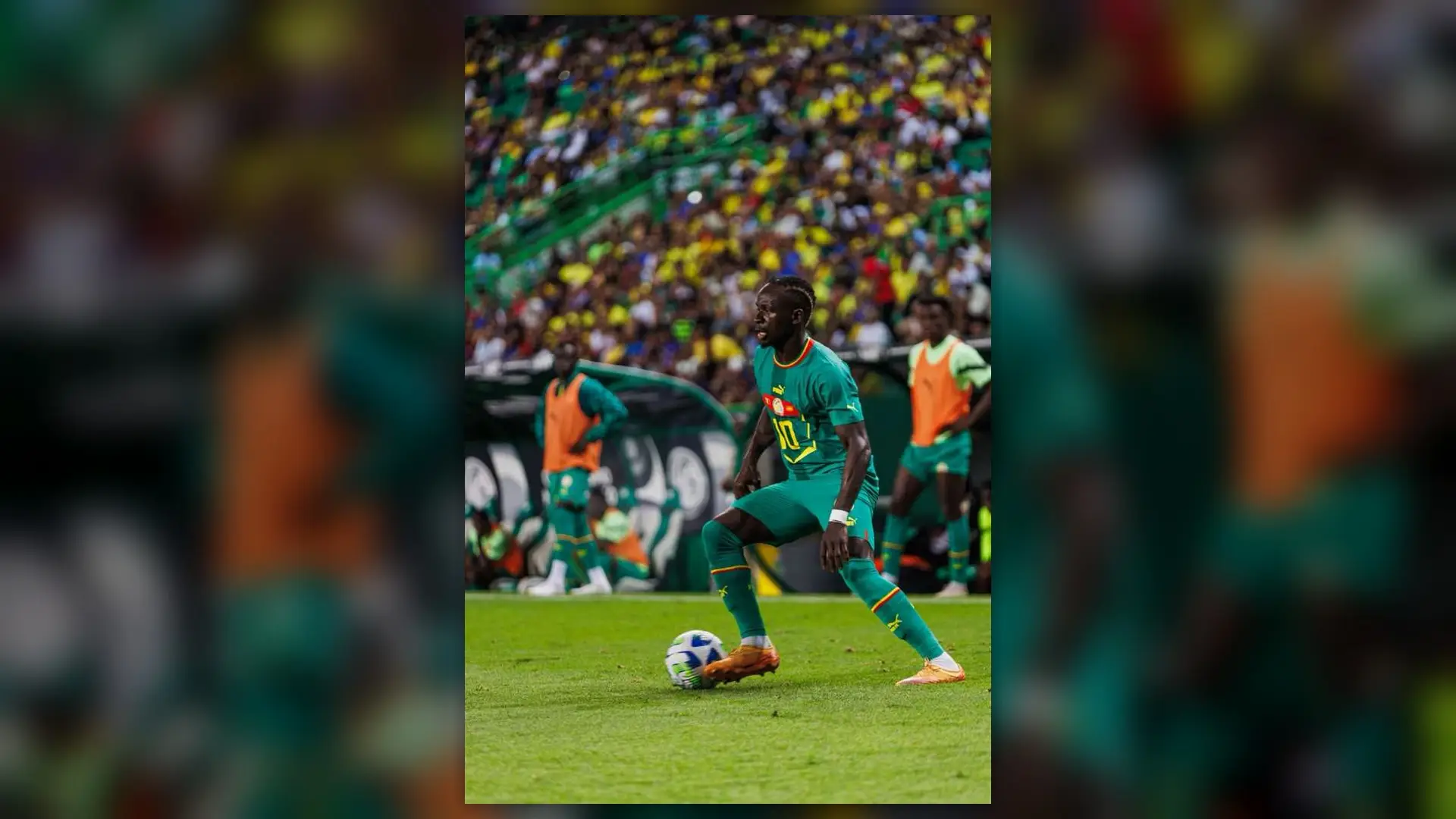 Senegal attacker in green kit controls the ball during Belgium vs Senegal