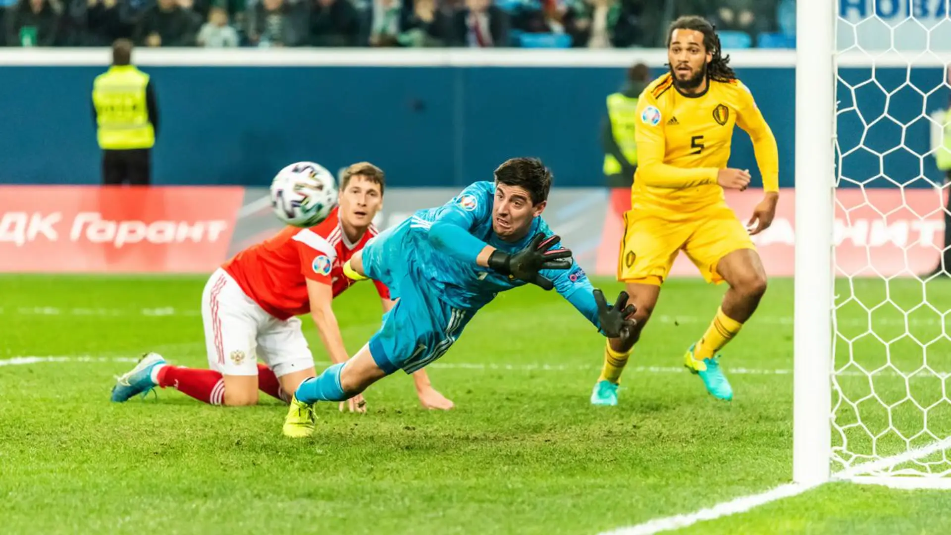 A goalkeeper dives across goal during an international match