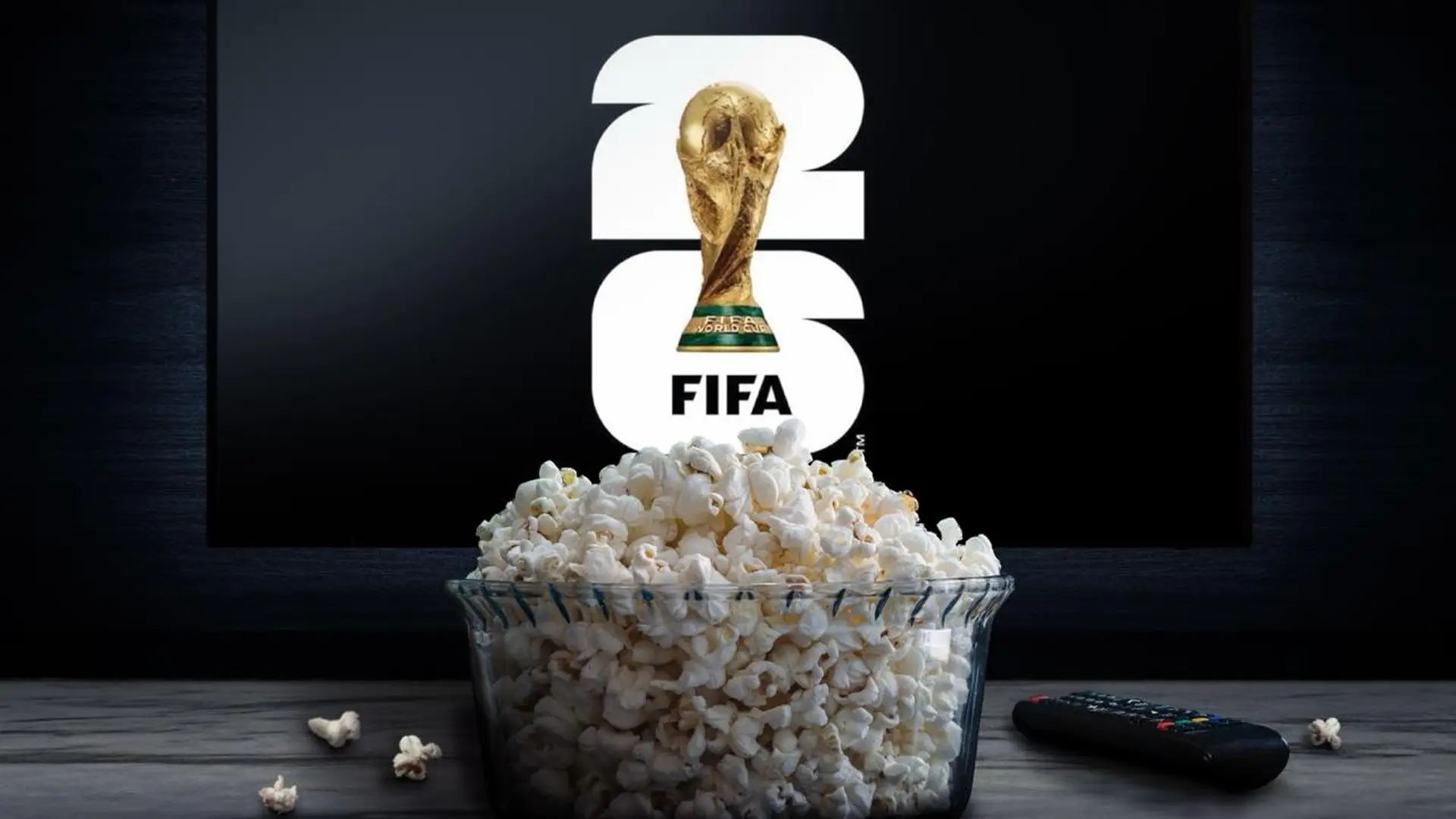 World Cup trophy displayed on a television behind a bowl of popcorn and a remote control.