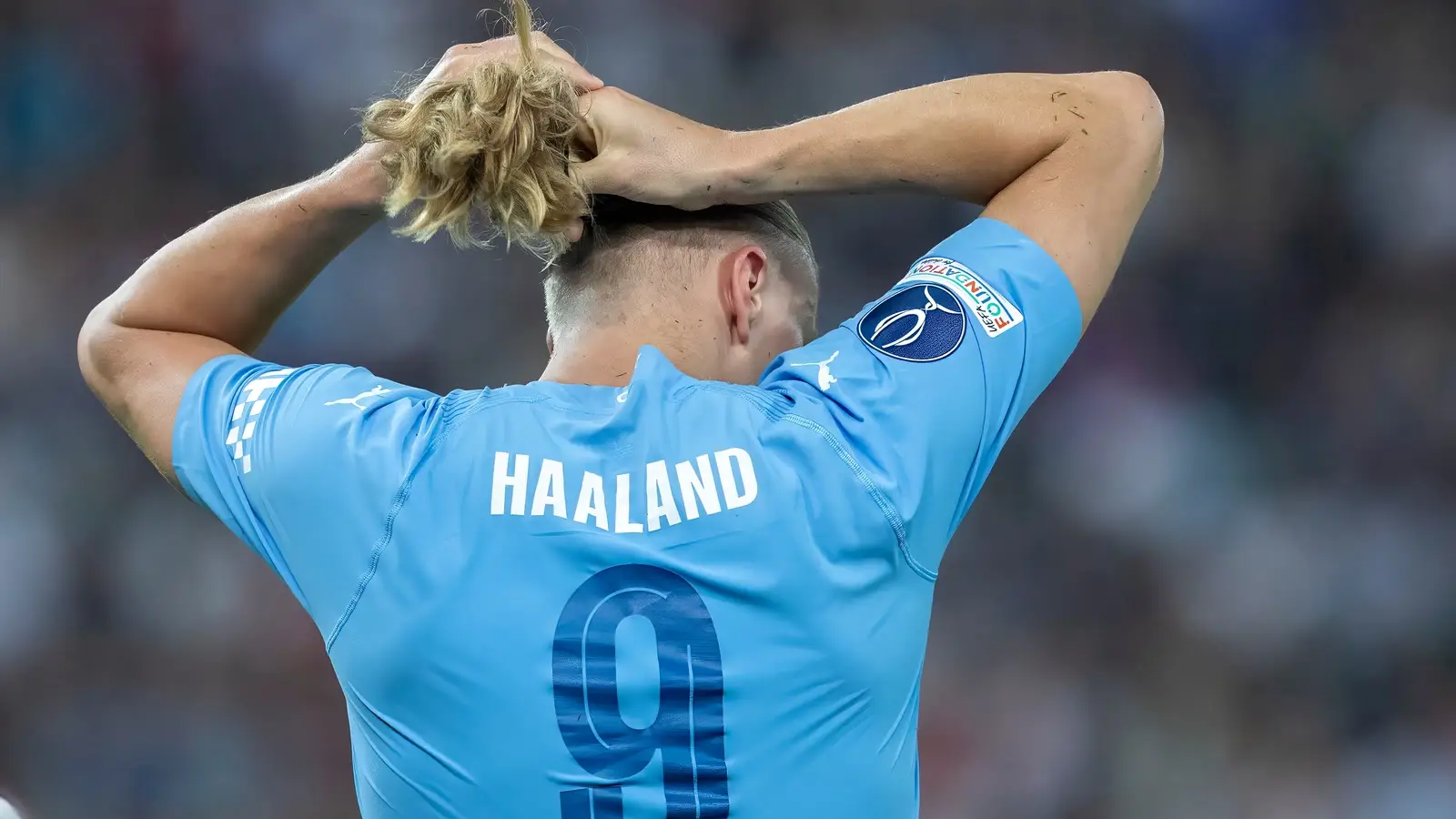 Erling Haaland in a Manchester City shirt with his hands on his head during the 2023 UEFA Super Cup.