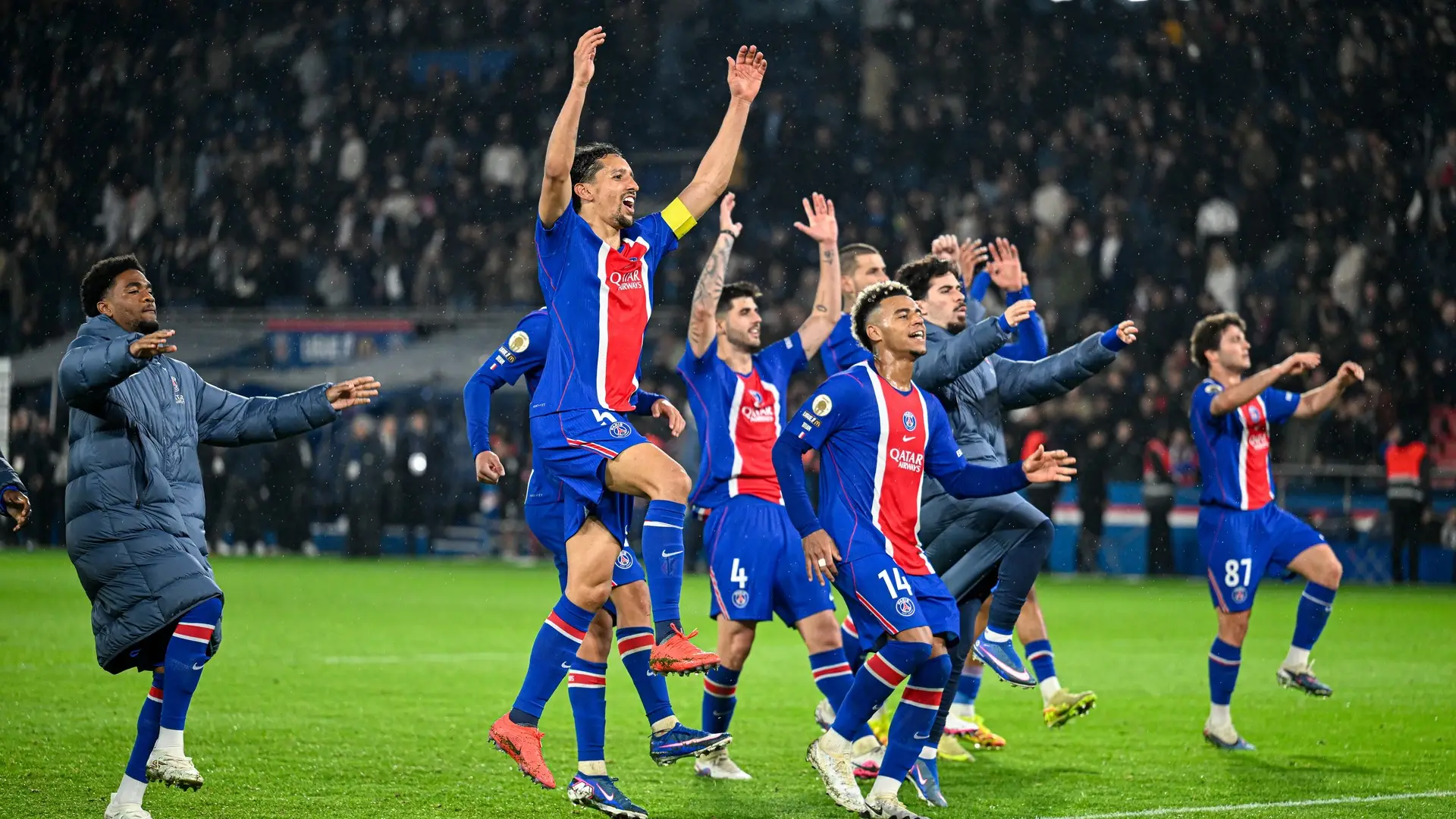 Paris Saint-Germain players celebrate together on the pitch