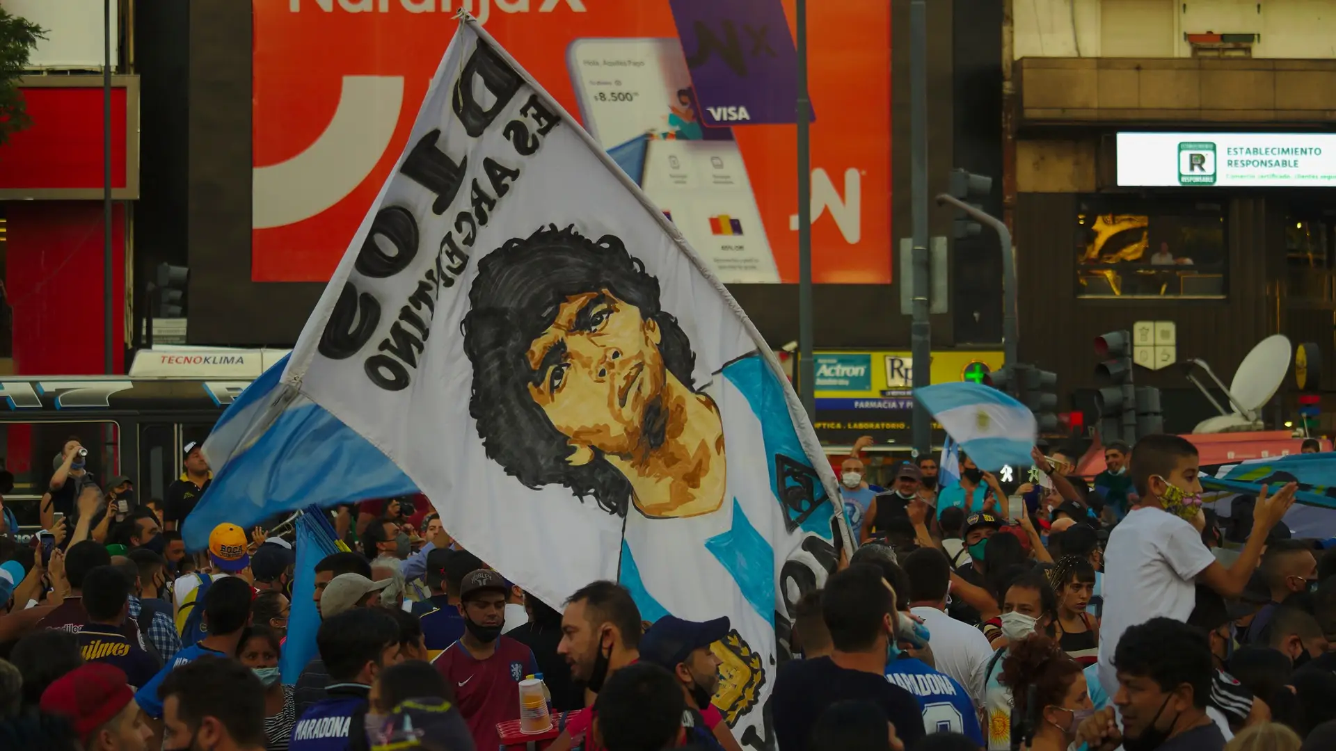A crowd carries a large Diego Maradona banner in Argentina
