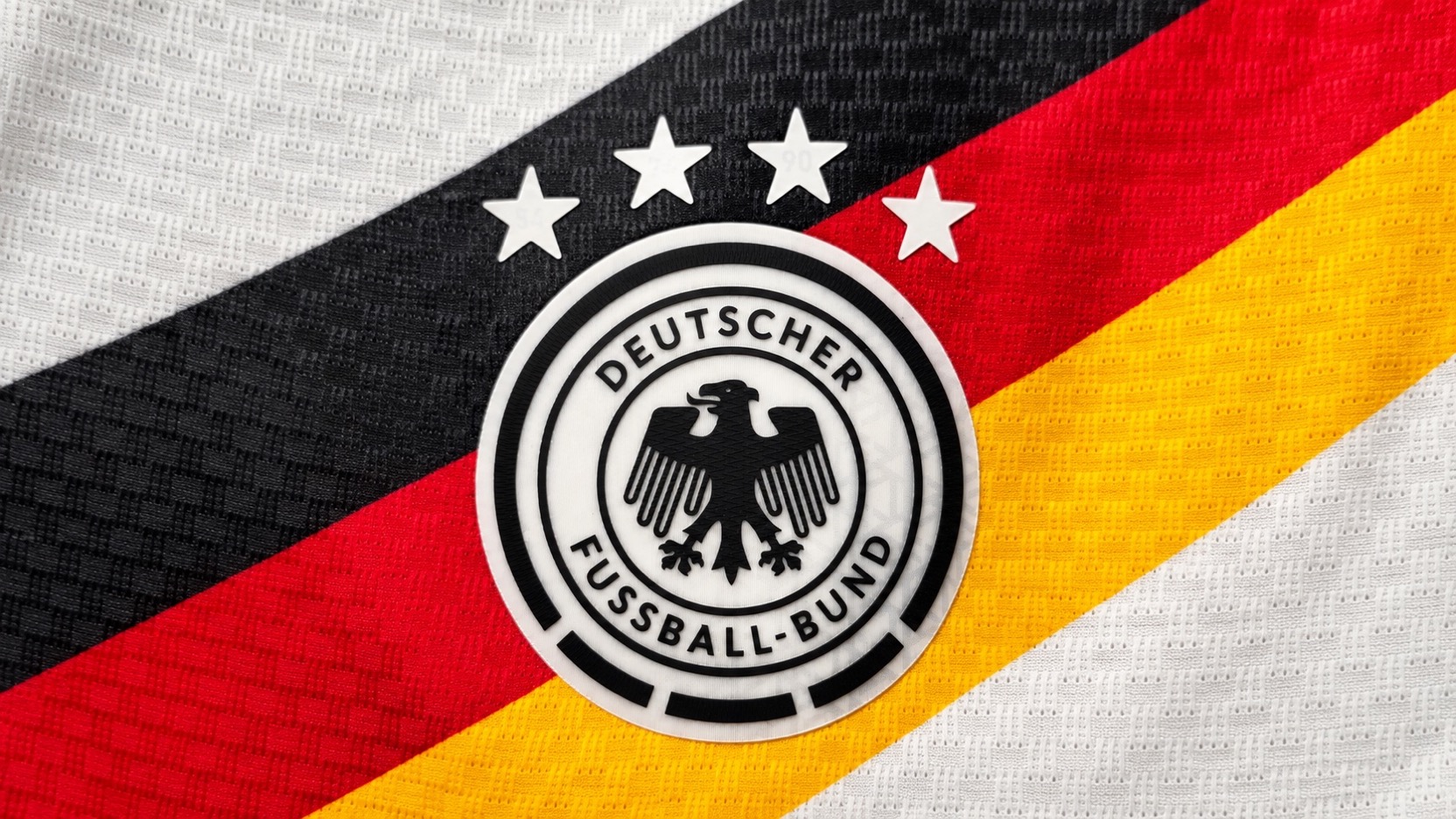 Germany football shirt with the DFB eagle crest, four stars and diagonal black, red and gold stripes
