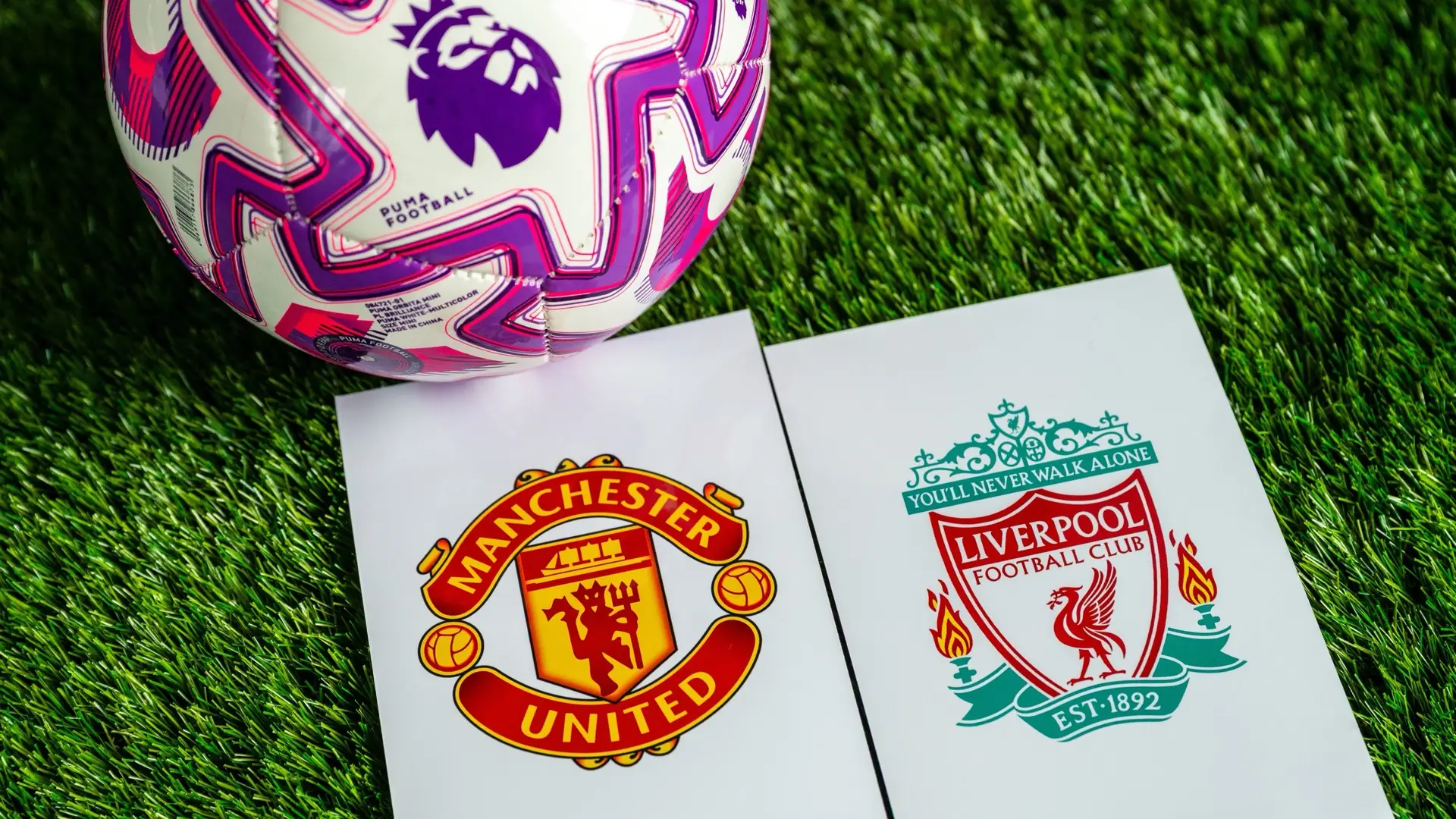 Manchester United and Liverpool crests beside a Premier League football