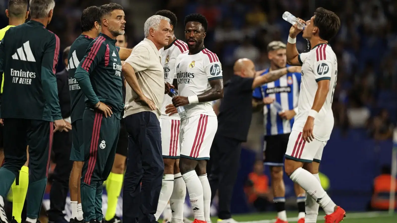 José Mourinho on the Real Madrid touchline with players during a La Liga match