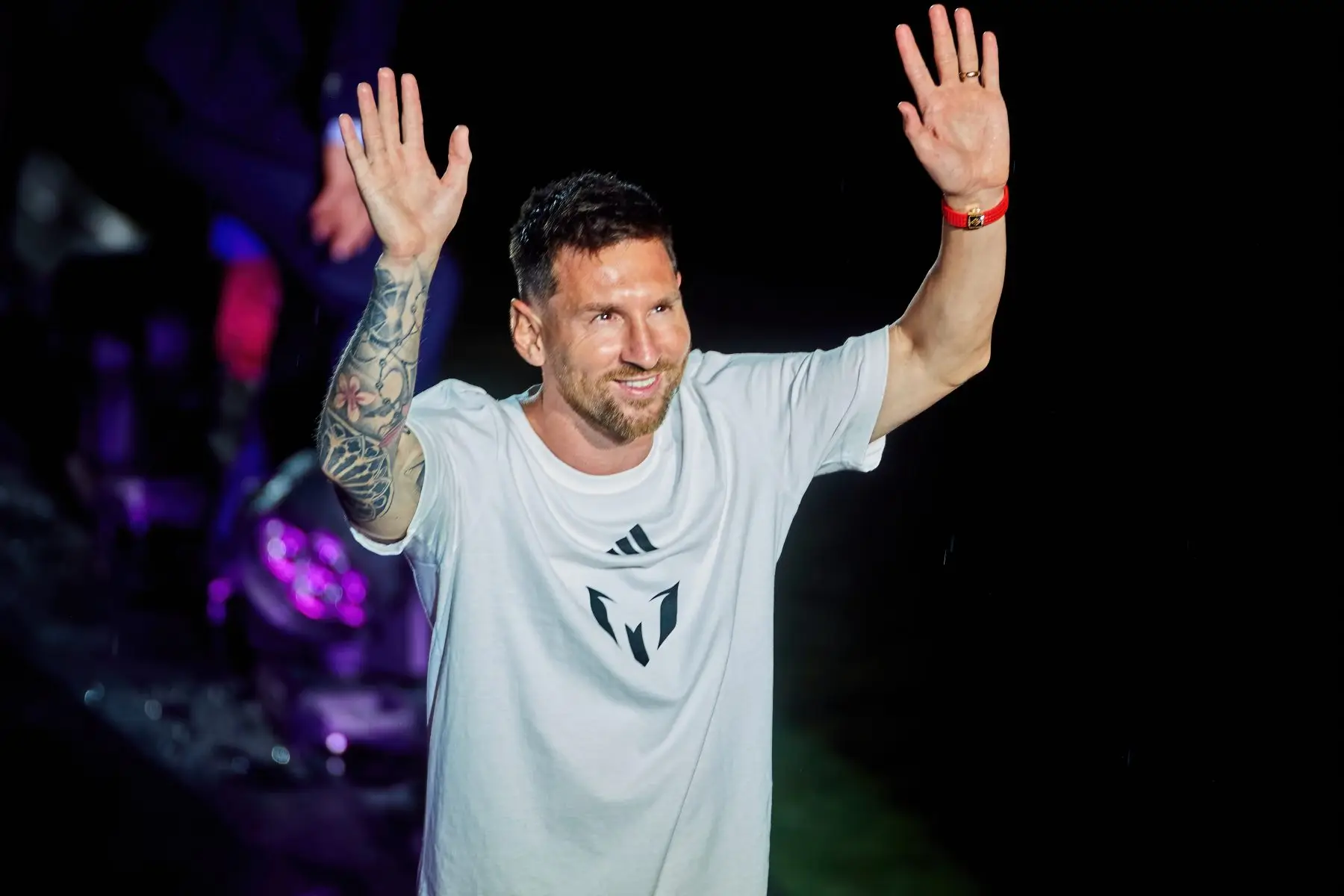 Lionel Messi, owner of clubs in Spain and Uruguay, waves to supporters