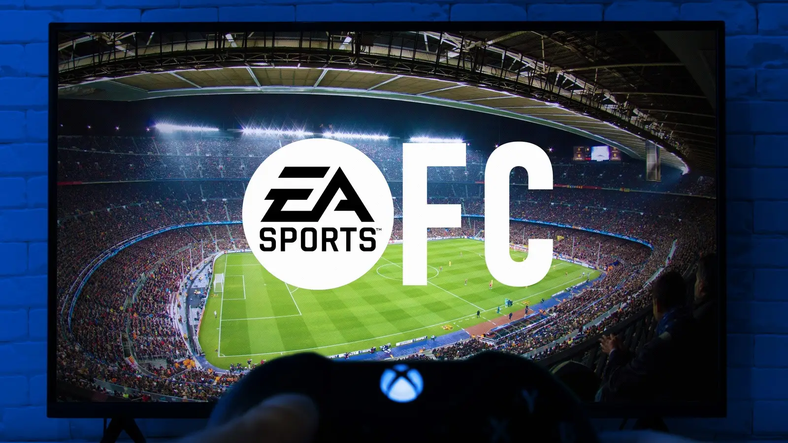 EA Sports FC logo displayed on a television as a player holds an Xbox controller.
