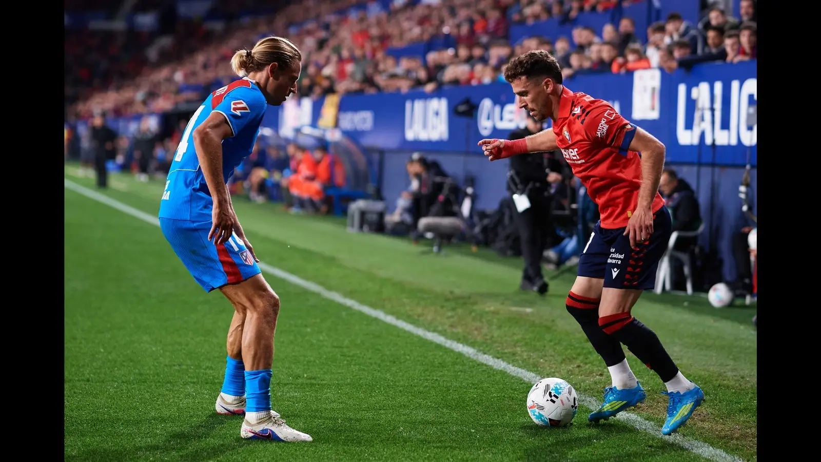 Marcos Llorente facing an opposing player with the ball at a LaLiga match