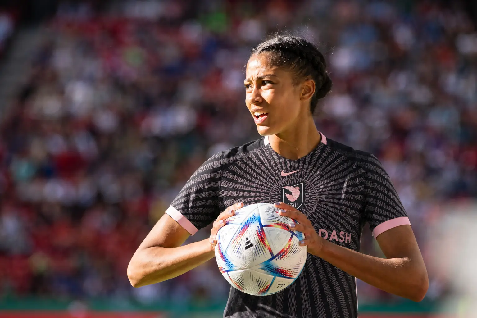 Sveindís Jónsdóttir pictured holding a soccer ball in an Angel City FC kit