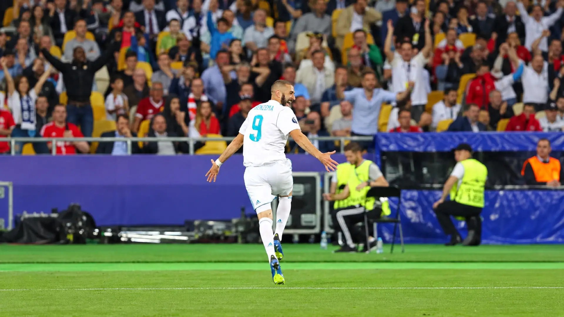 Karim Benzema celebrates with arms outstretched in Real Madrid’s white number 9 shirt
