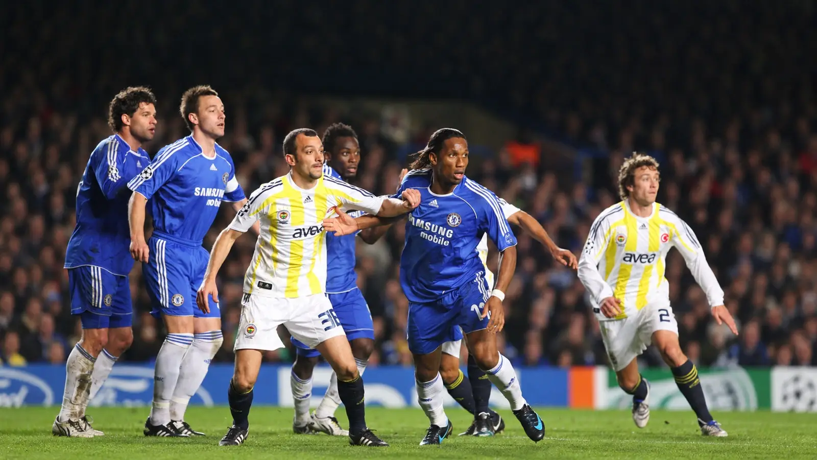 Didier Drogba and Chelsea teammates jostle with Fenerbahçe players during a Champions League match.