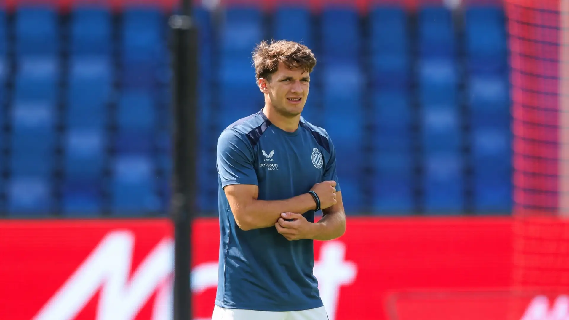 Greece international Christos Tzolis in a Club Brugge training shirt at a stadium.