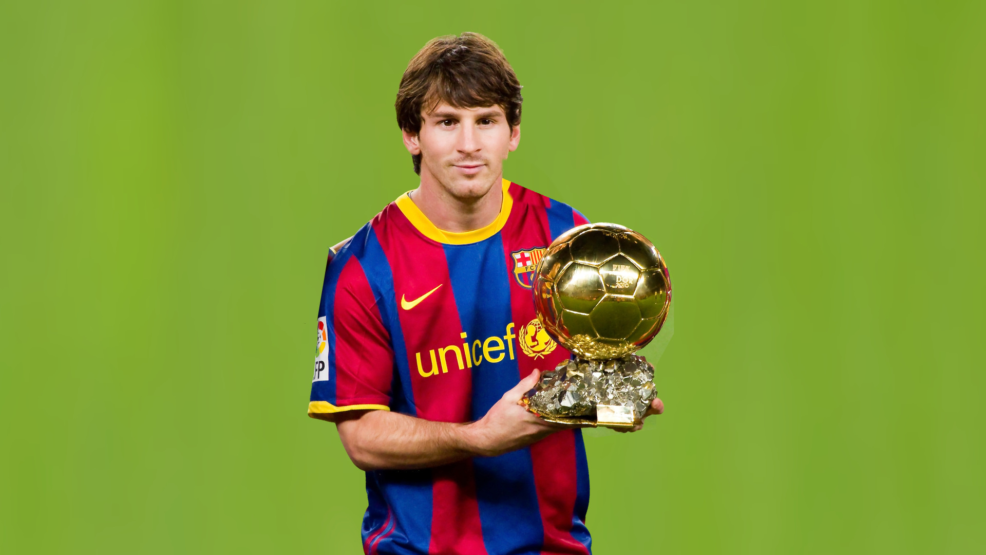 Lionel Messi in a Barcelona shirt holding the 2010 FIFA Ballon d’Or trophy.