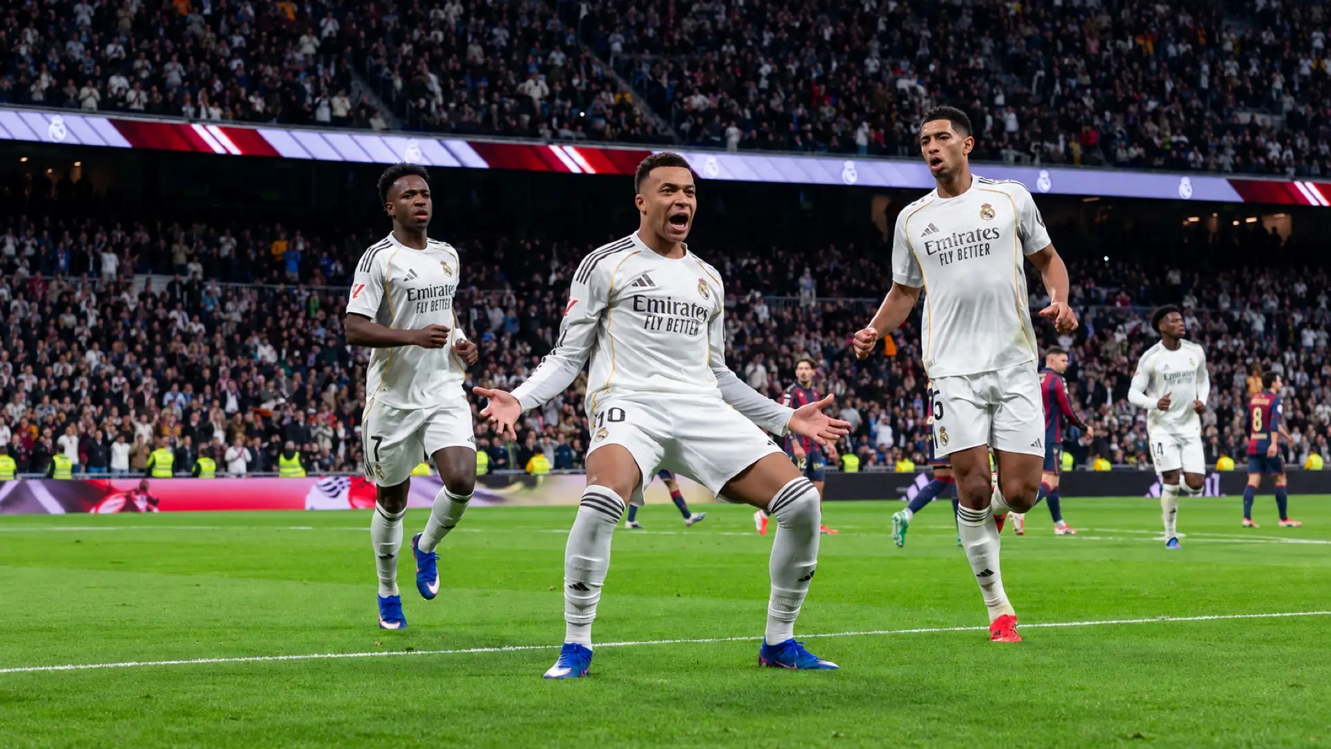 Kylian Mbappé celebrates for Real Madrid alongside Vinícius Júnior and Jude Bellingham.