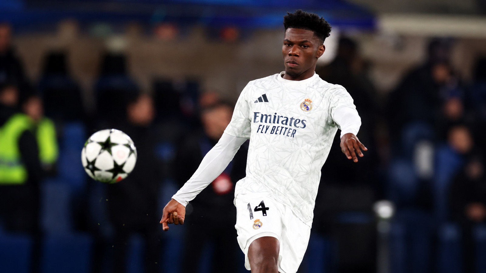 Aurélien Tchouaméni in a white Real Madrid kit with a football during warm-up
